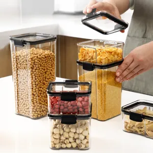 Clear plastic food storage container set with airtight black lids on white countertop.