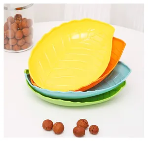 Leaf-shaped plastic fruit plate detail view, colorful candy dish close-up display