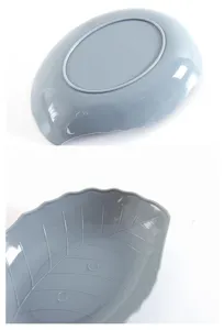 Grey plastic leaf shaped snack dish detail view showing texture and bottom structure.