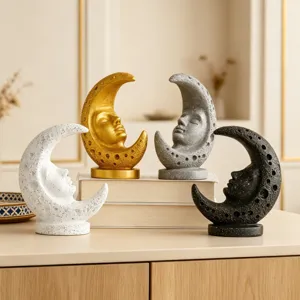 Close-up detail of vintage moon face resin statues set, elegant celestial decor pieces.