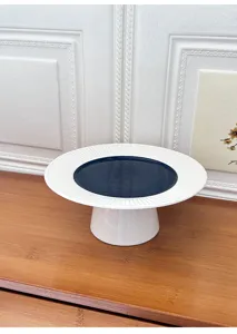 Modern minimalist ceramic cake stand with fluted ray rim and high pedestal for dessert cafe fruit display.