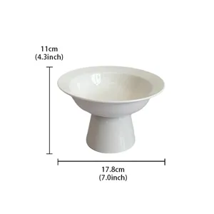 Detailed view of the elegant white ceramic high-footed fruit bowl, showcasing smooth surface.