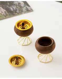 Close-up of wooden and golden metal incense burner detail, elegant tabletop home decor.