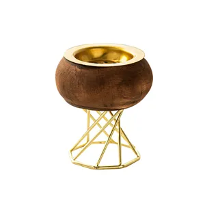 Wooden and metal incense burner with gold geometric stand, elegant tabletop decor for home.