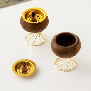 Wooden incense burner with golden metal geometric stand, perfect for home desktop decor.