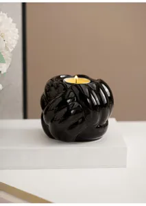 Dettaglio portacandela in ceramica nera nodo di filo, elegante supporto lumino.