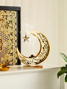 Gold hollow metal moon star incense burner for aromatherapy table decor, elegant design.