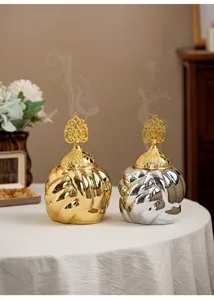 Modern minimalist ceramic incense burner with metallic electroplated finish and golden lid.