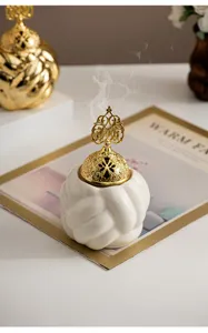 Modern minimalist ceramic incense burner with gold lid, perfect home decor for living room.