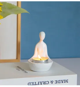 Vue détaillée du porte-bougie en résine motif figurine humaine pour une ambiance zen chaleureuse.