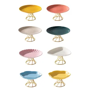 Modern minimalist ceramic cake stand fruit plate with geometric metal base, various shapes.