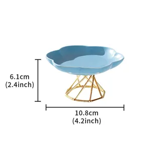 Modern minimalist ceramic fruit plate with luxury gold metal geometric stand for dessert.