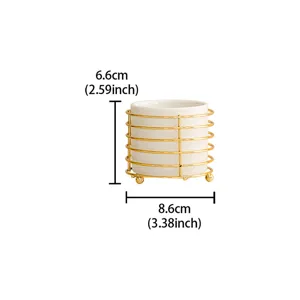 White ceramic chopstick holder storage jar with gold metal wire frame and compact desktop size.