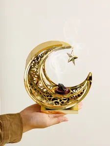 Detail view of the gold hollow crescent moon incense burner, showcasing exquisite metal cutout design.