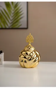 Gold ceramic incense burner detail shot, modern minimalist aroma diffuser home decor piece.