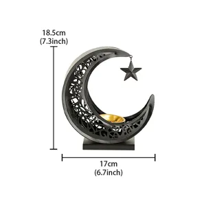 Close-up detail view of a black metal crescent incense burner with hanging star and golden dish.