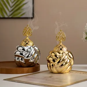 Modern ceramic yarn ball incense burner with hollow gold lid for home aromatherapy decor.