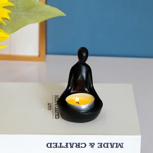 Bougeoir minimaliste abstrait en résine avec figurine méditative pour la décoration.