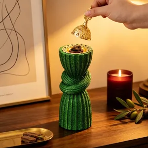 Arabic style green glitter resin incense burner detail, elegant middle eastern craft decor.