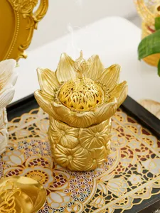 Golden Arabic lotus incense burner detail, creative hollow metal aroma diffuser jar.
