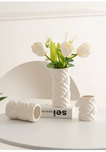 Modern minimalist ceramic vase set featuring braided texture design, elegant home decor detail.