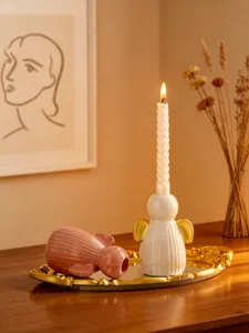 Vue détaillée du bougeoir ange en céramique, décoration de table minimaliste.