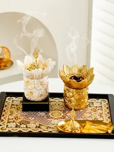 Detail shot of Middle Eastern Arabic golden lotus incense burner with smoke effect.