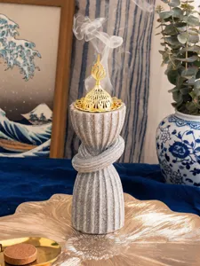 Detailed view of Arabic style resin incense burner featuring an ornate gold metal lid.