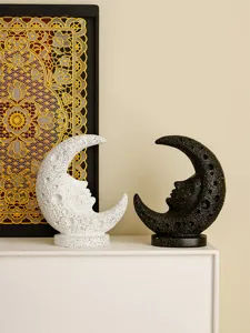 Detail shot of medieval vintage moon face resin sculpture pair, artistic desktop ornament decor.