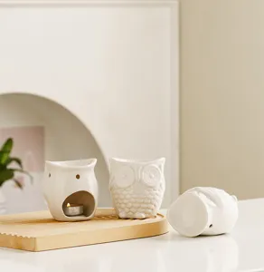 White ceramic owl oil burner detail shot, cute animal candle holder for home decor and aromatherapy.
