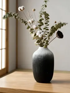 Minimalist black and white gradient resin vase with dried eucalyptus for home decoration.