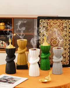 Middle Eastern style resin incense burner, elegant knot design with golden hollow lid for home decor.