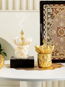 Detail shot of creative lotus flower incense burner set, elegant gold and white design for tabletop decor.