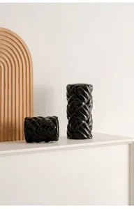 Minimalist black braided ceramic vase detail shot, modern sculptural home decor accessory.