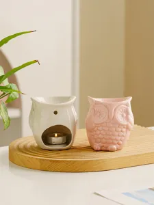 Ceramic owl aroma burner detail showing cute pink and white candle holder home decor.