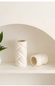Detail shot of modern minimalist white ceramic braided rope texture vase for elegant home decor.