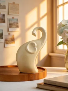 Detail shot of a sleek ceramic elephant figurine on a wooden tray, elegant home desk decor.