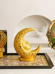 Golden crescent moon face resin sculpture detail, vintage celestial tarot art decor item.
