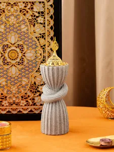Arabic style resin incense burner with sparkly grey twisted body and ornate gold lid.