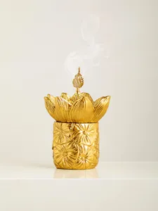Golden lotus incense burner for aromatherapy and sandalwood cones, elegant decorative jar.