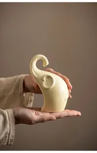 Detailed close-up of a minimalist ceramic elephant figurine, smooth texture for home decor.