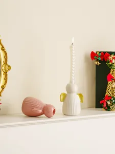 Vue détaillée de bougeoirs anges en céramique moderne et minimaliste, parfaits pour table maison.