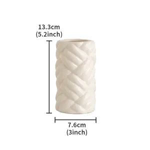 Detailed view of the modern ceramic vase with unique braided texture and compact size for decor.