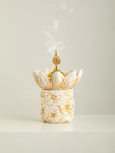 Detail shot of the luxury gold middle eastern style floral incense burner, elegant smoke effect.