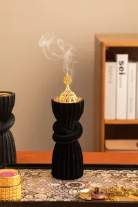 Arabic style resin incense burner with gold filigree lid, black textured home decor piece.