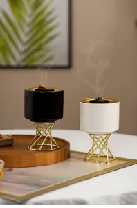 Modern nordic ceramic incense burner with metal stand for home table decor detail view.