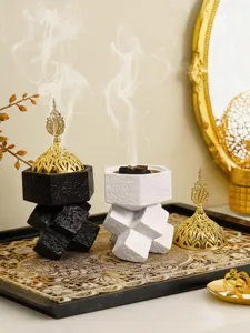 Detailed shot of Arabic resin incense burner with golden hollow lid and unique geometric shape.