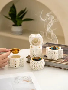 Detailed shot of creative 3D printed ceramic incense burners with delicate hollow design.