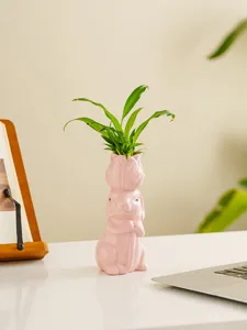 Close-up detail of the pink ceramic rabbit vase with tulip head design, ideal for table decoration.