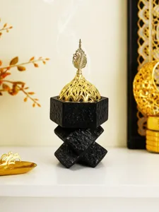 Detailed close-up of a Middle Eastern style resin incense burner with an ornate golden lid.